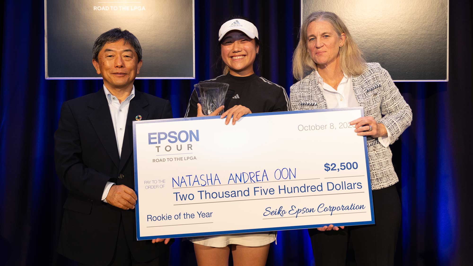 Natasha Andrea Oon with trophy and check