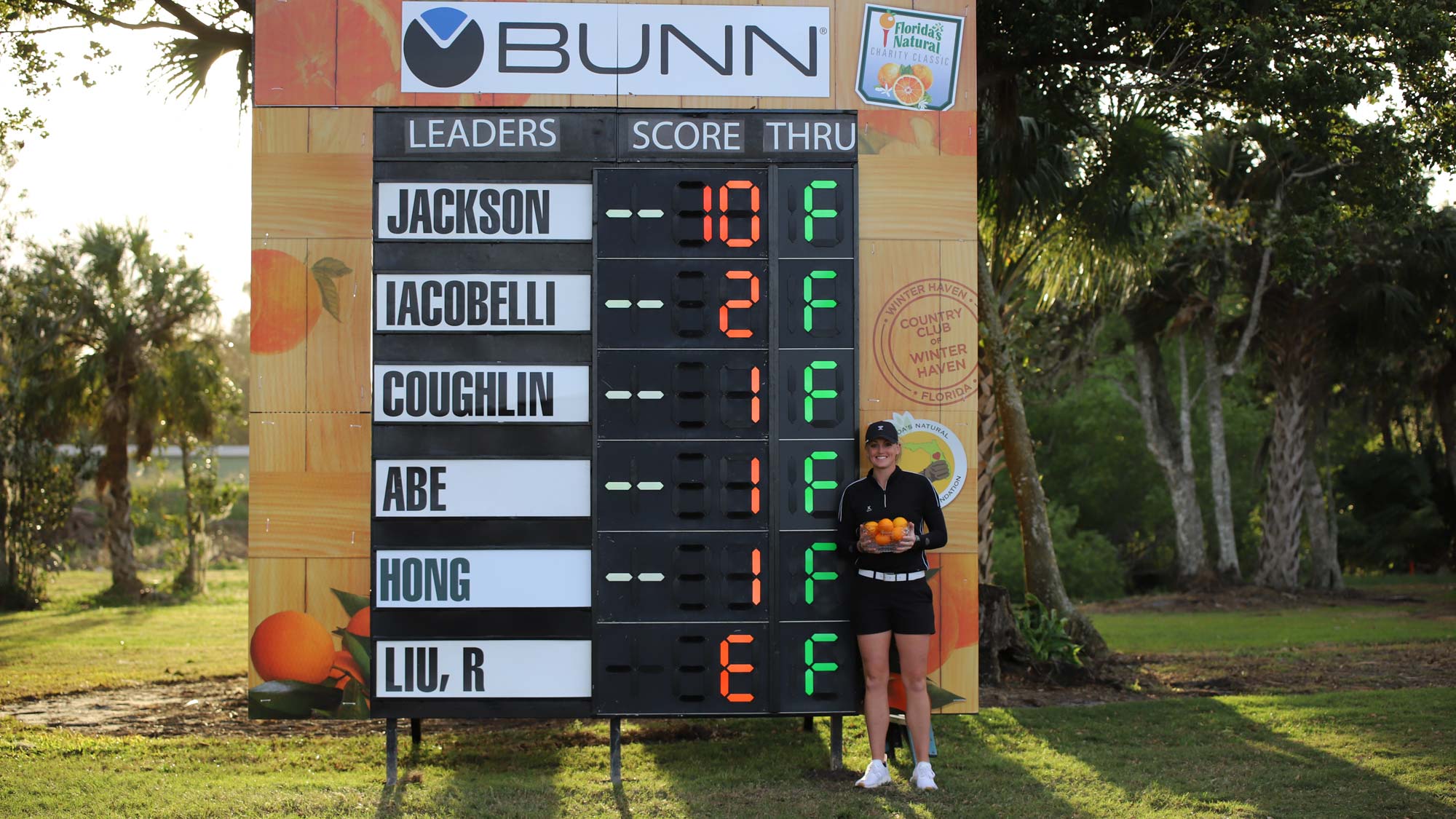 Janie Jackson with trophy at leaderboard 